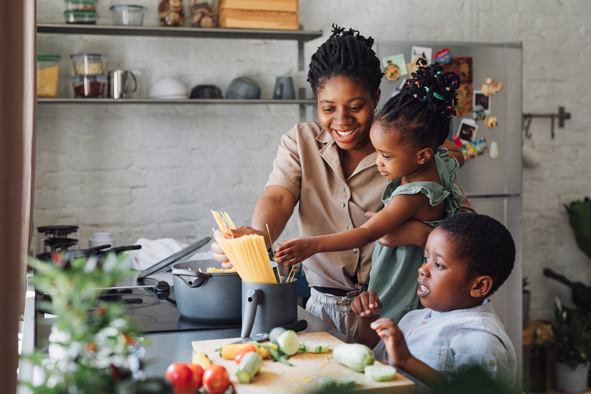 mom and kids making food in kitchen