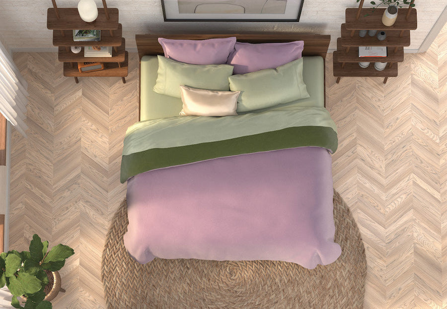 Top-down image of a Lilac- and Sage-colored bed in a tan room