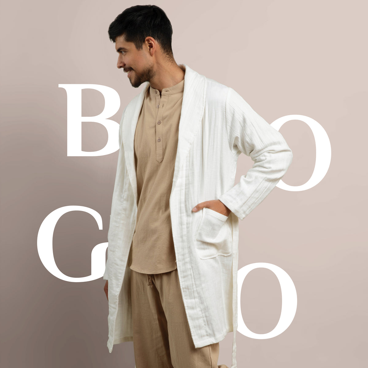 Image of a man dressed in tan pajamas wearing a white Featherweight Robe with BOGO in white letters behind him
