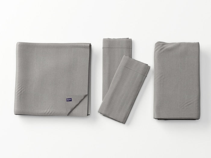 Image of Dove Gray Deluxe Cool Stretch Sheet Set left to right: Folded flat sheet with folded corner, two folded pillowcases, folded fitted sheet