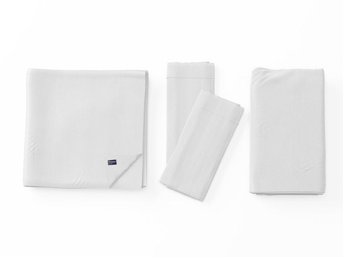 Image of White Deluxe Cool Stretch Sheet Set left to right: Folded flat sheet with folded corner, two folded pillowcases, folded fitted sheet