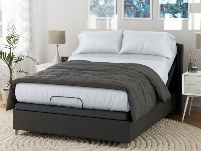Image of a dressed bed on an adjustable base with White Deluxe Cool Stretch Sheets and a dark gray comforter on top