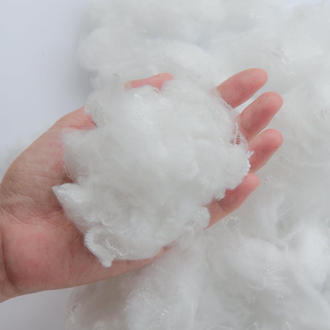 Close-up image of polyester fiber in a hand