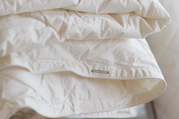 Image of white folded duvet insert featuring slot for duvet cover ties