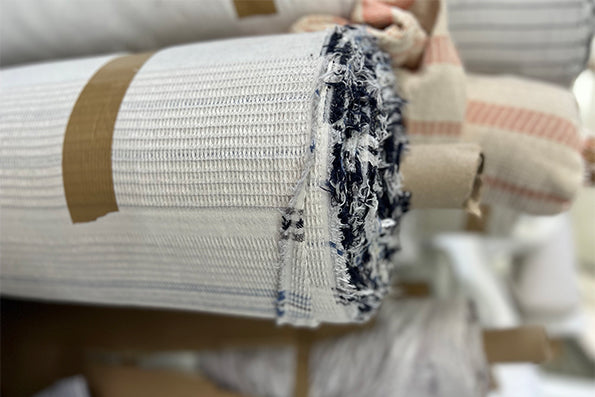 Image showcasing a roll of quilted fabric in a warehouse