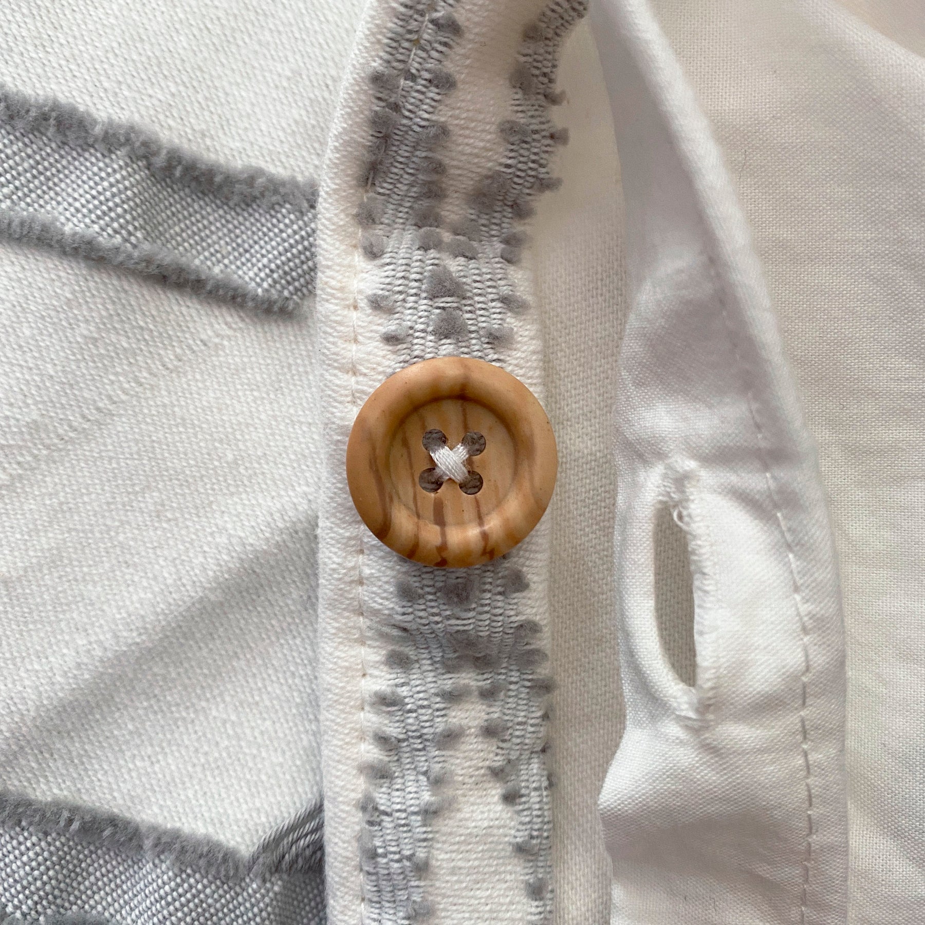 Close-up image of the Sonoran Duvet Cover showcasing the wooden button feature 
