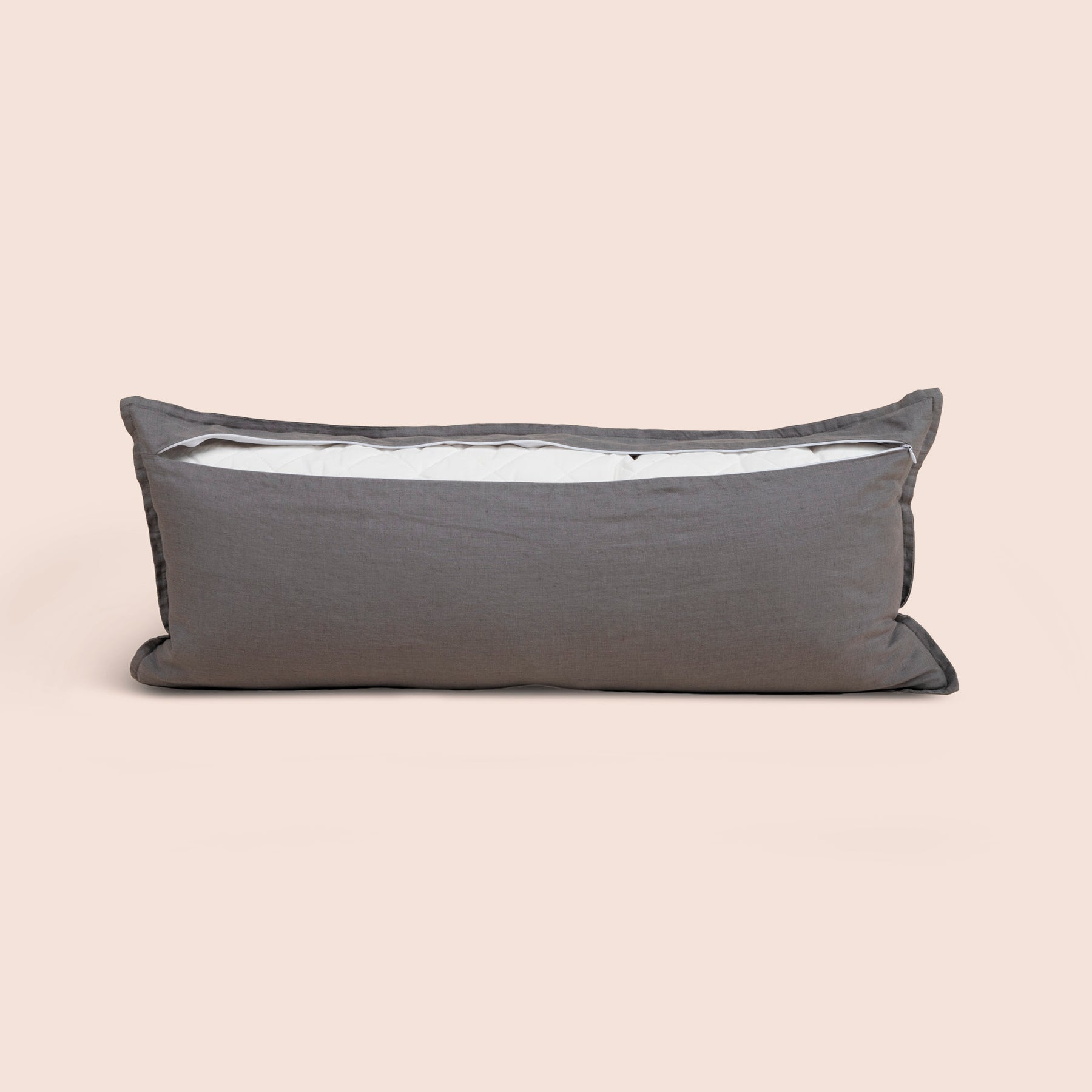 Image of the back of the Stone Gray Blended Linen Lumbar Pillow Cover on a lumbar pillow with the back zipper open on a light pink background