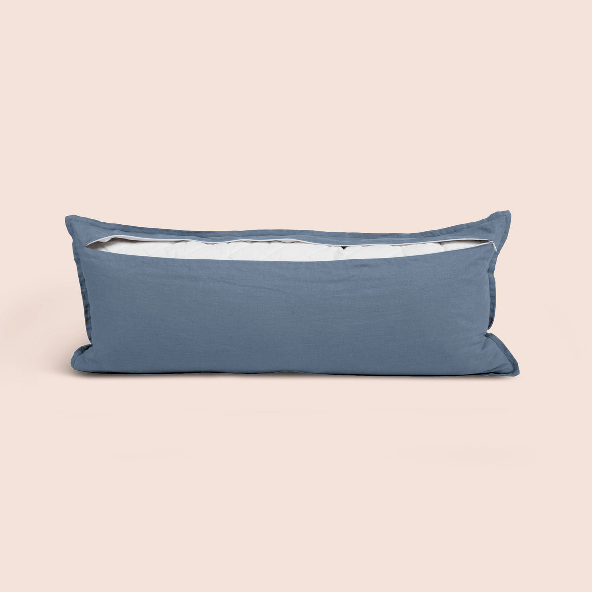 Image of the back of the Catalina Blue Blended Linen Lumbar Pillow Cover on a lumbar pillow with the back zipper open on a light pink background
