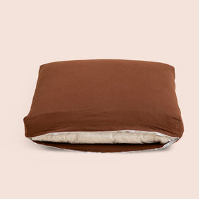 Image of Cacao Blended Linen Meditation Cushion Cover showcasing an open zipper with a meditation cushion inside on a light pink background 