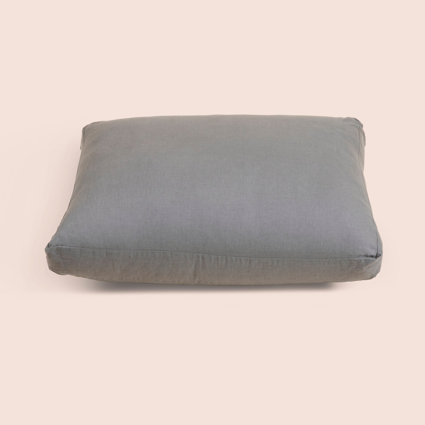 Image of Stone Gray Blended Linen Meditation Cushion Cover on a meditation cushion with a light pink background