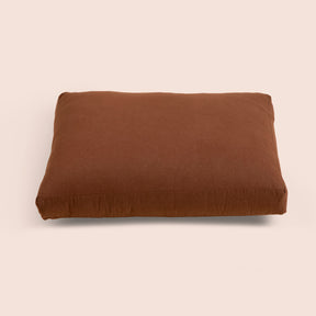 Image of Cacao Blended Linen Meditation Cushion Cover on a meditation cushion with a light pink background