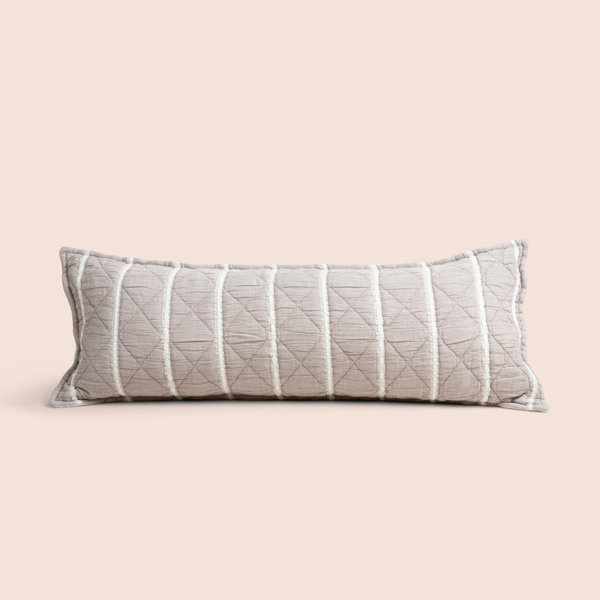 Image of the gray and white striped reversible side of the Heritage Lumbar Pillow Cover on a lumbar pillow with a light pink background
