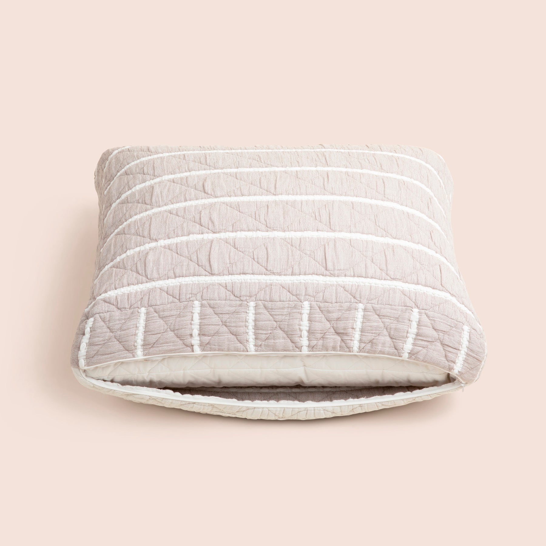 Image of the gray and white striped reversible side of the Heritage Meditation Cushion Cover showcasing an opened zipper with a meditation cushion inside on a light pink background