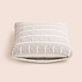 Image of the gray and white striped reversible side of the Heritage Meditation Cushion Cover showcasing an opened zipper with a meditation cushion inside on a light pink background 
