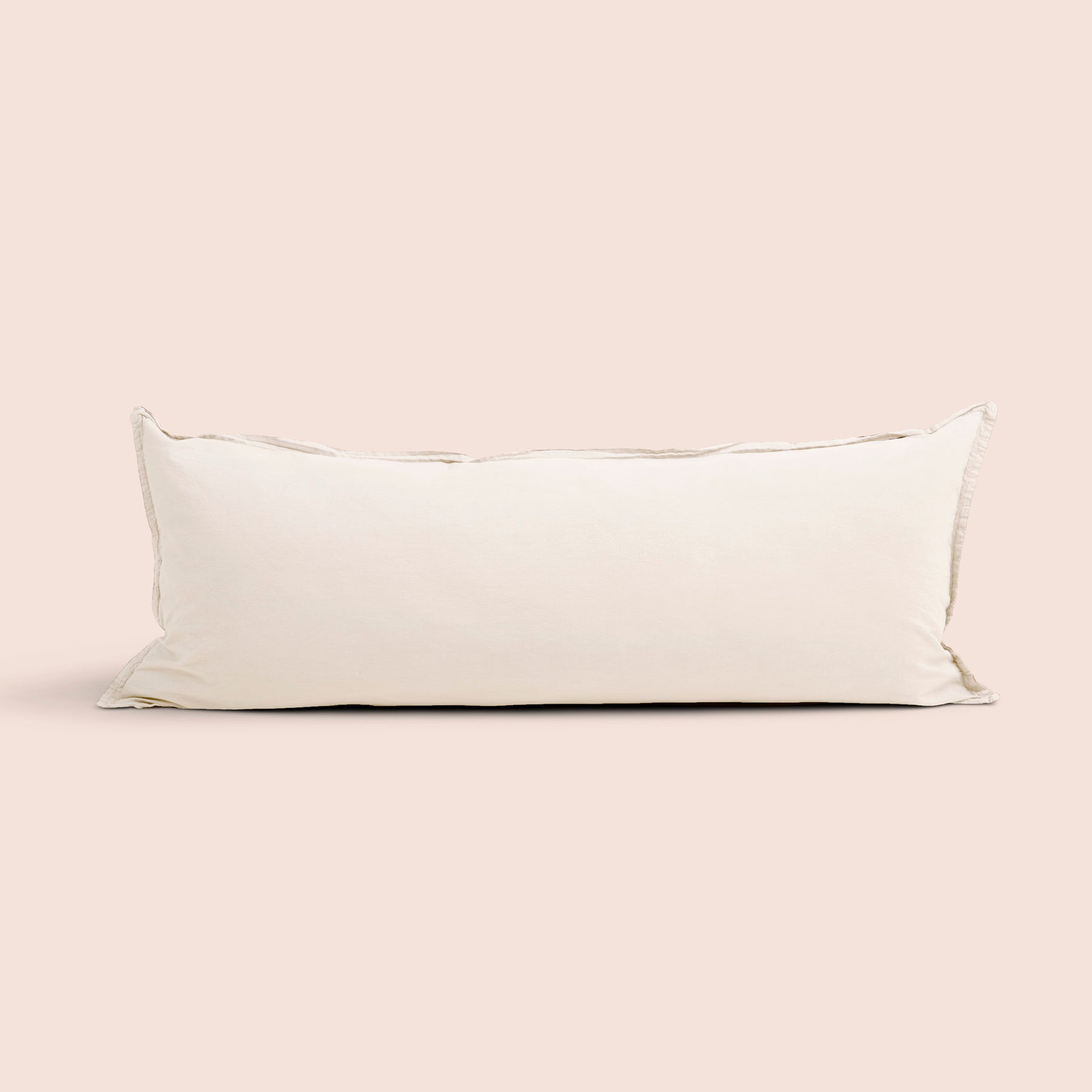 Image of Ecru Garment Washed Percale Lumbar Pillow Cover on a lumbar pillow with a light pink background