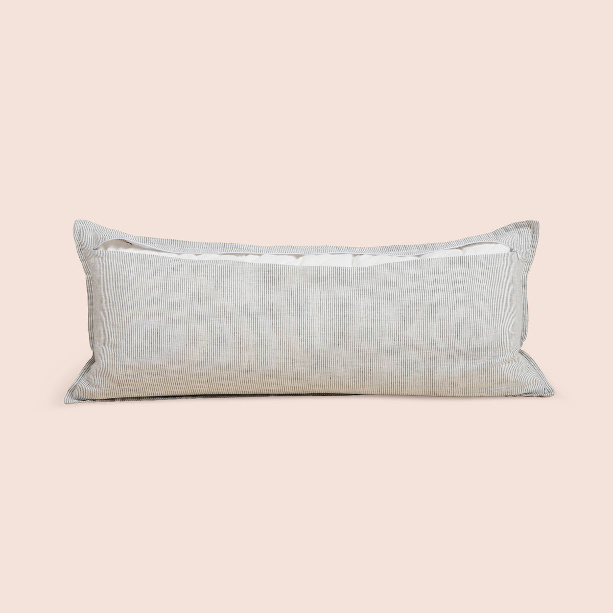 Image of the back of the Pinstripe Relaxed Hemp Lumbar Pillow Cover on a lumbar pillow with the back zipper open on a light pink background