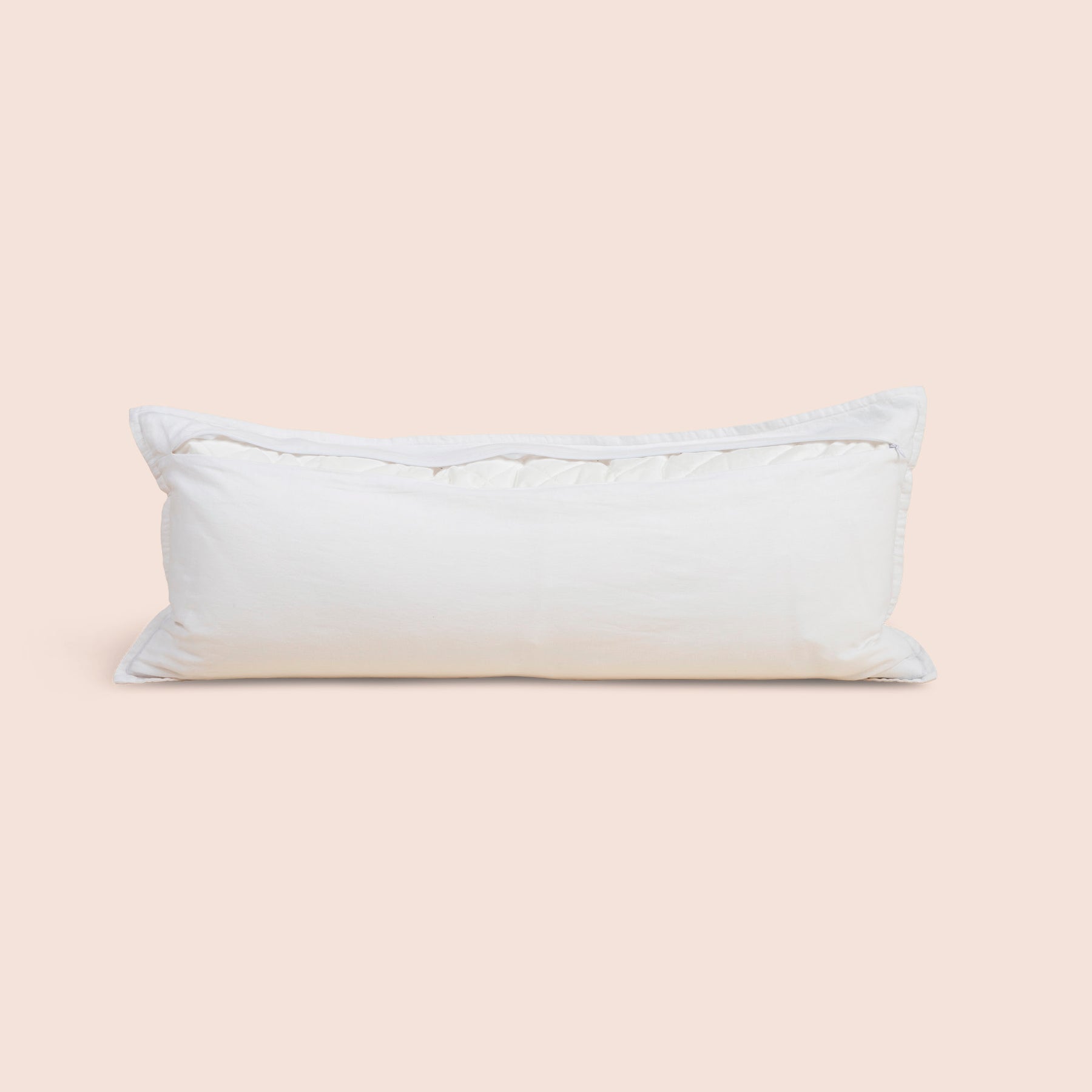 Image of the back of the White Relaxed Hemp Lumbar Pillow Cover on a lumbar pillow with the back zipper open on a light pink background