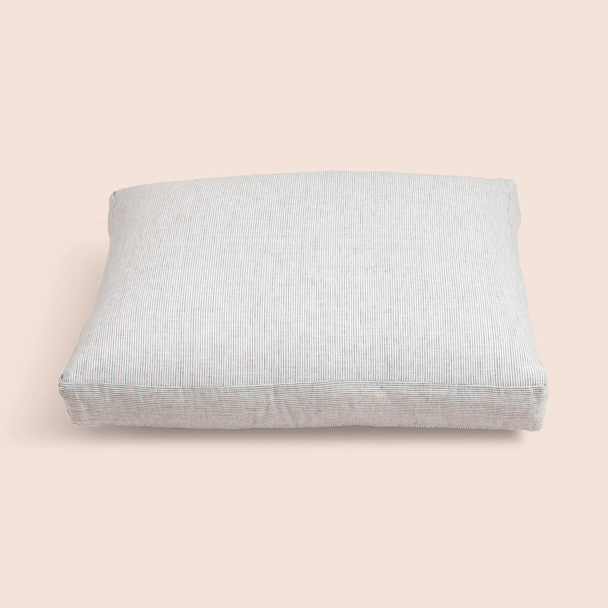 Image of the Pinstripe Relaxed Hemp Meditation Cushion Cover on a meditation cushion with a light pink background