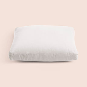 Image of the White Relaxed Hemp Meditation Cushion Cover on a meditation cushion with a light pink background