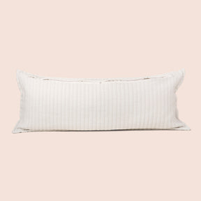 Image of the back of the Ecru Ridgeback Lumbar Pillow Cover on a lumbar pillow with the back zipper open on a light pink background
