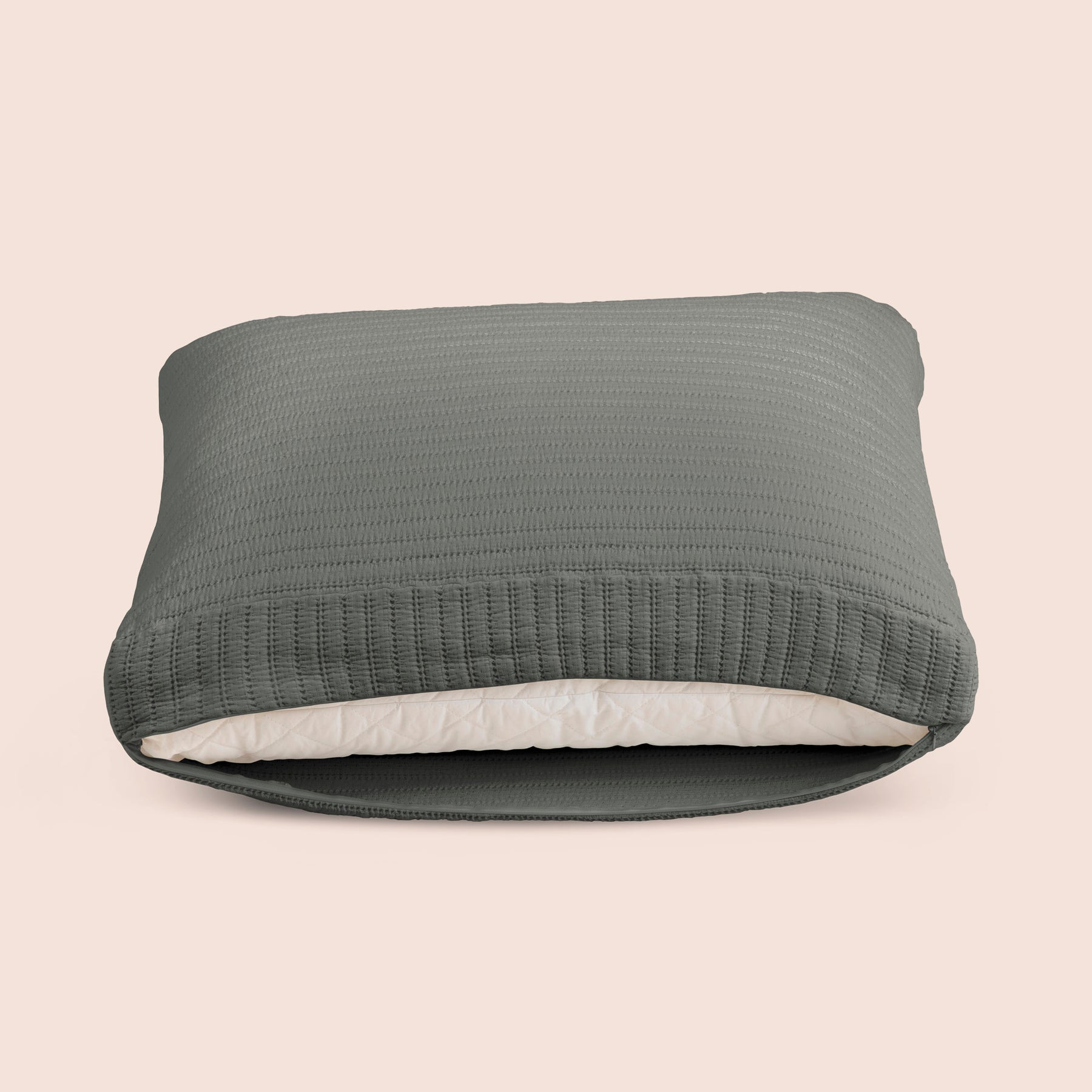 Image of the Agave Ridgeback Meditation Cushion Cover showcasing an opened zipper with a meditation cushion inside on a light pink background 