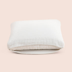 Image of the Ecru Ridgeback Meditation Cushion Cover showcasing an opened zipper with a meditation cushion inside on a light pink background 