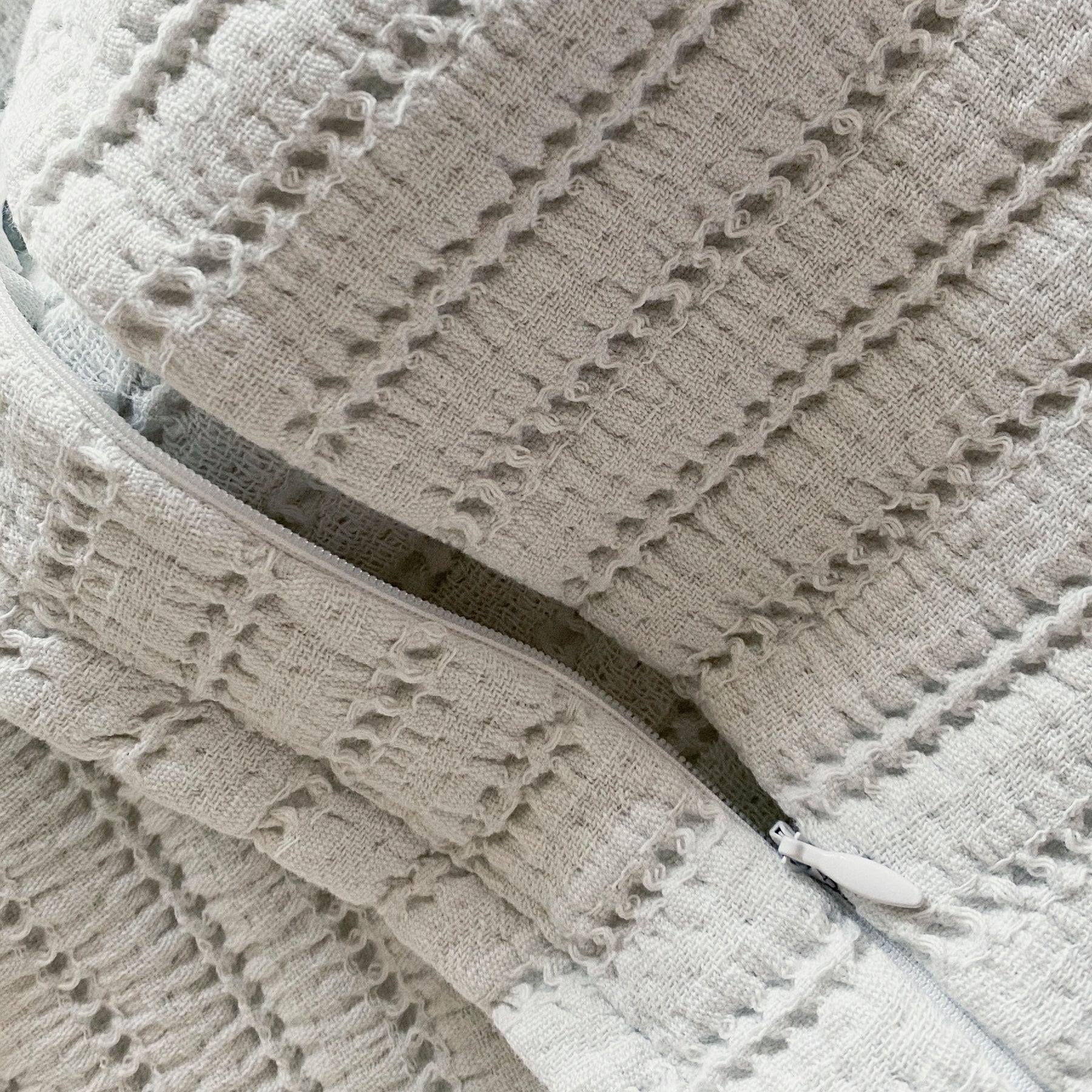 Close-up image of the Ecru Ridgeback Meditation Cushion Cover showcasing the zipper 