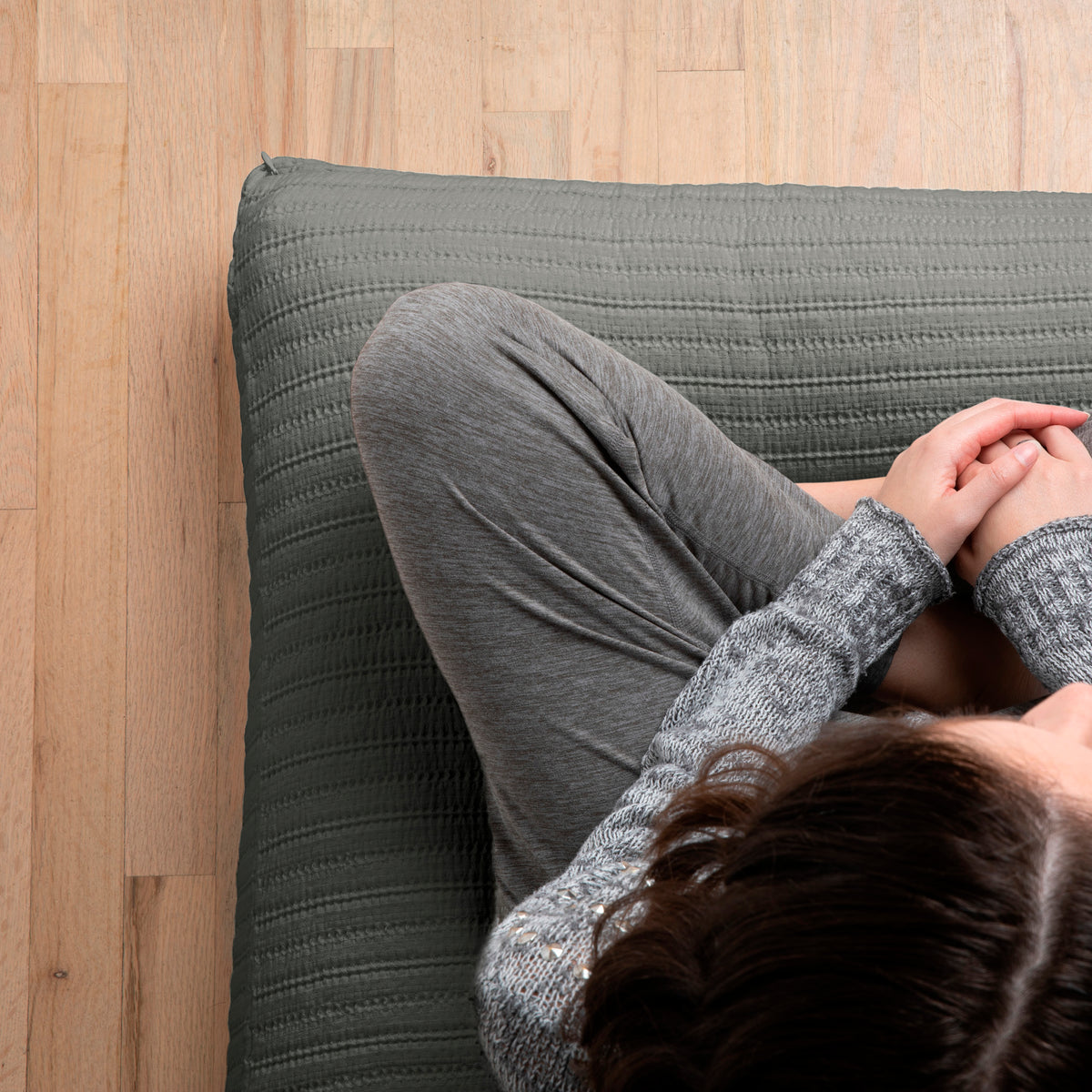 Image of woman sitting cross-legged on a meditation cushion with the Agave Ridgeback Meditation Cushion Cover