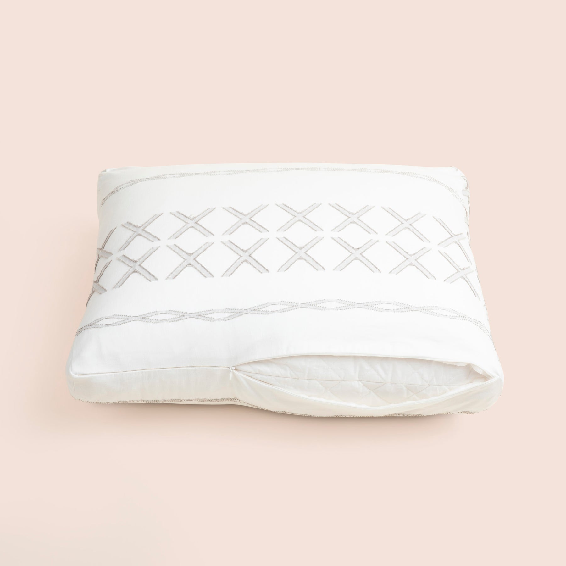 Image of the Sonoran Meditation Cushion Cover showcasing a slightly opened zipper with a meditation cushion inside on a light pink background 