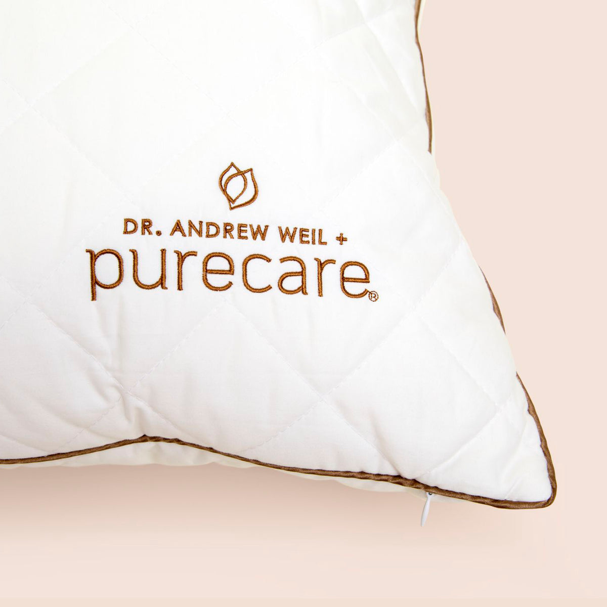 Close-up image of the Dr. Andrew Weil + Purecare logo on bottom right corner of All Seasons Wool Pillow