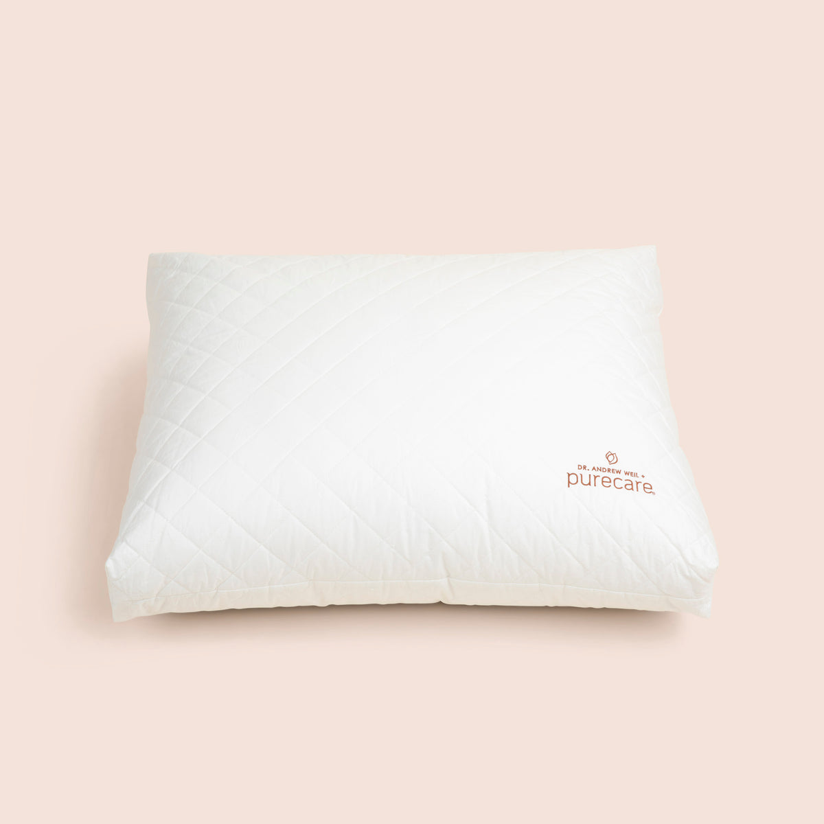 Image of a white, square Meditation Cushion shown from an top-angled view on a light pink background with the Dr. Andrew Weil + Purecare logo sewn on in the bottom right corner