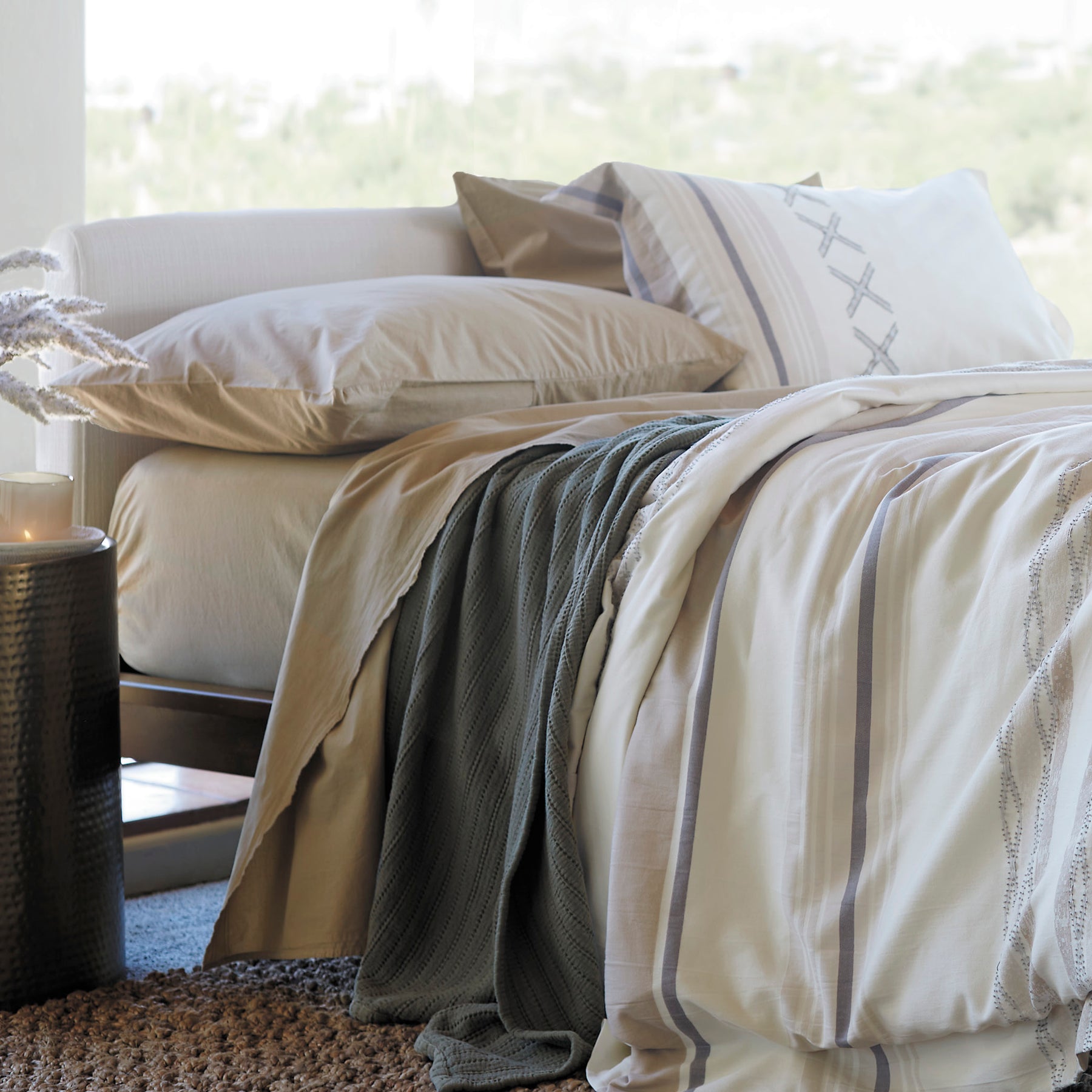 Image of a naturally-made bed with Ochre Garment Washed Percale Sheets, an Agave Ridgeback Coverlet, and a Sonoran Duvet Cover
