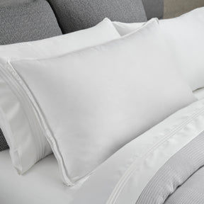 Image of a Cooling Down Pillow on a gray and white bed