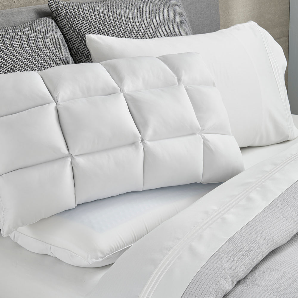 Image of a SoftCell® Chill Pillow on a gray and white bed
