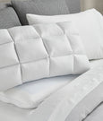 Image of a SoftCell® Pillow on a gray and white bed