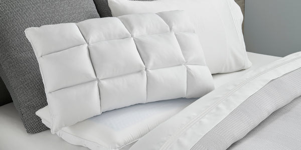 Image of a SoftCell® Pillow on a gray and white bed