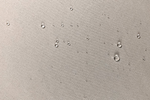 Close-up image of protector fabric with water droplets across the middle