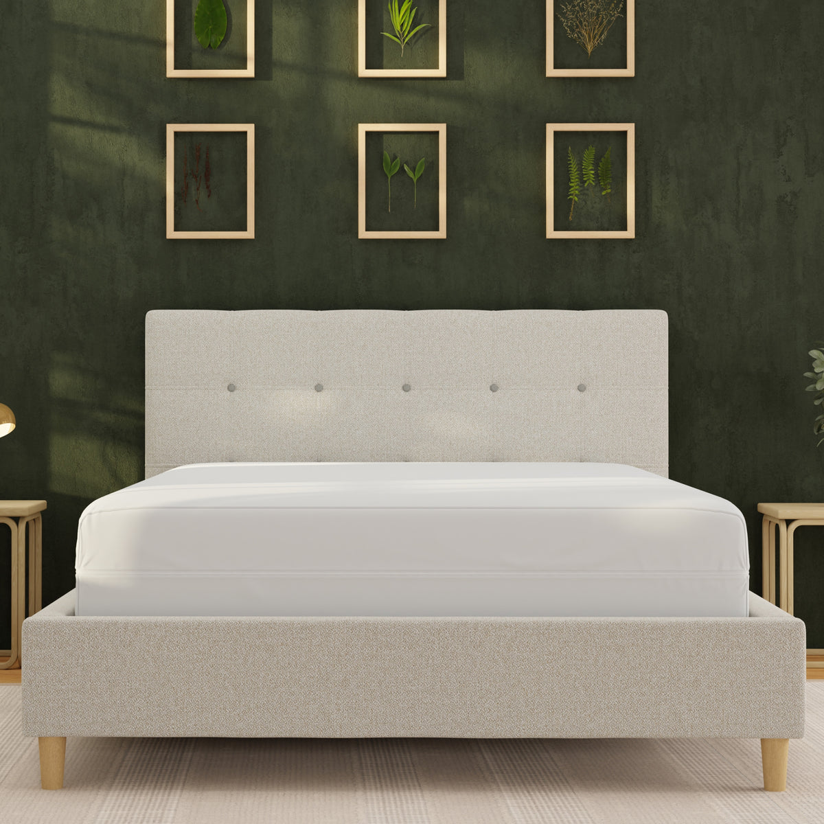 Image of a mattress protector on a bed in a dark green room taken from the foot of the bed