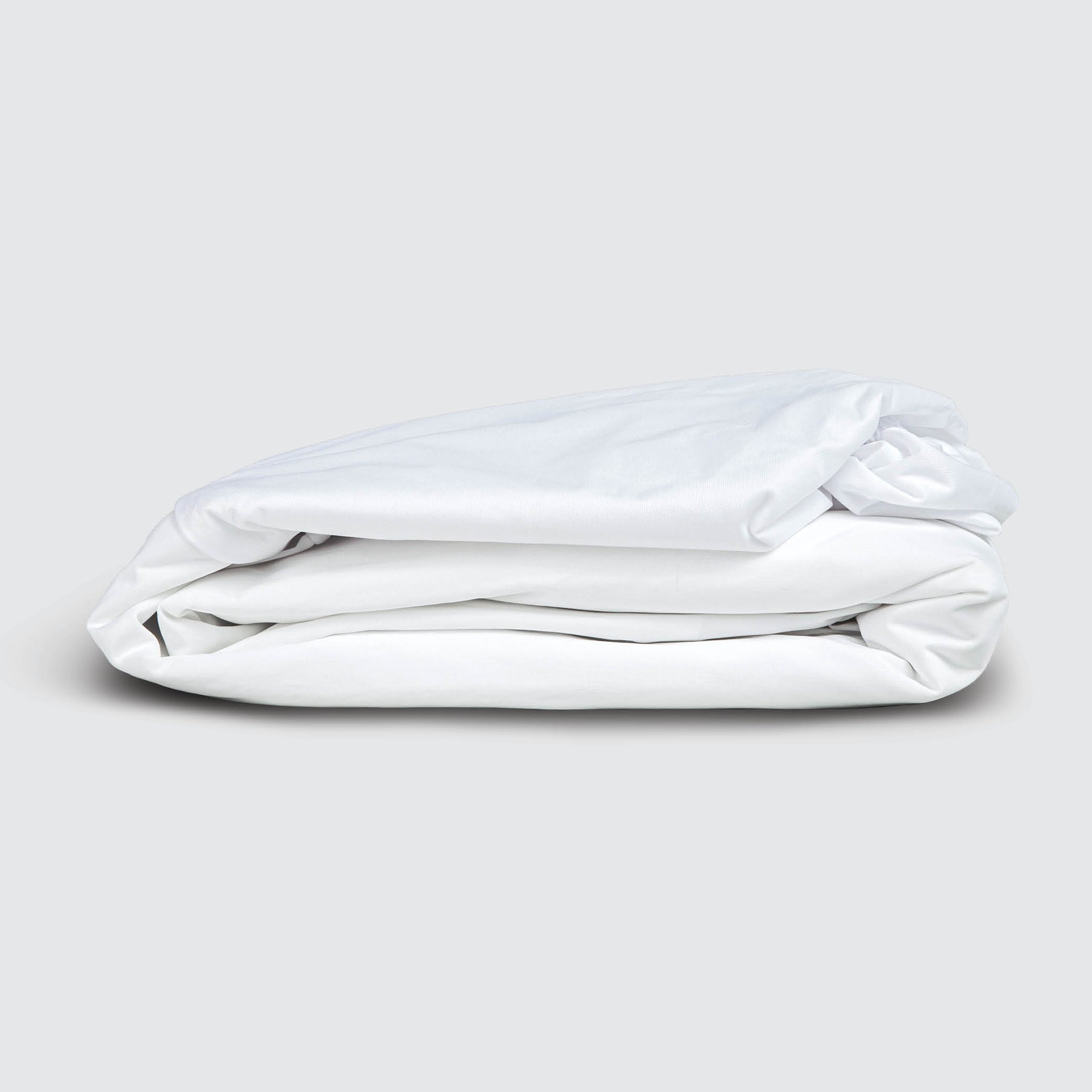Image of a folded Cooling 5-Sided Mattress Protector on a white background