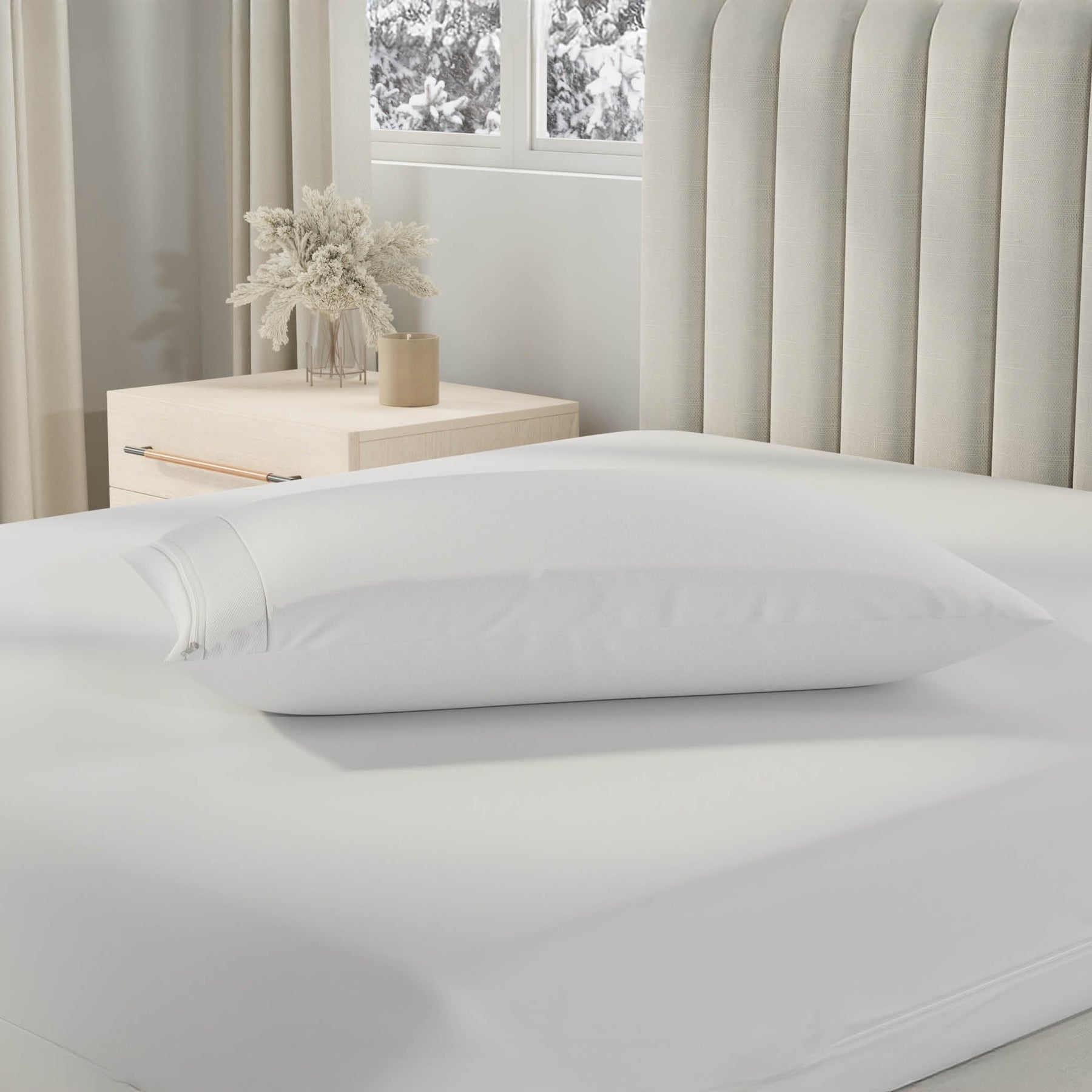Image of a pillow with a Cooling Pillow Protector on it on top of a bed with just a Total Encasement Mattress Protector