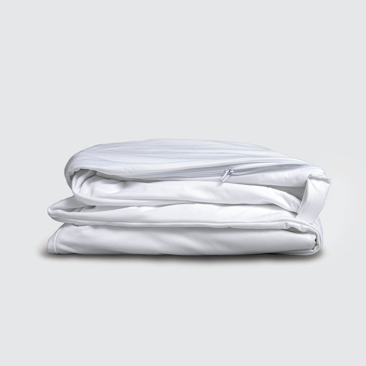 Image of a folded white mattress encasement on a white background