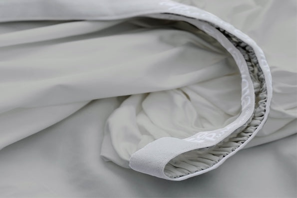 Close-up image of the 1" elastic Precision-Fit® cuff on a Dove Gray Recovery fitted sheet