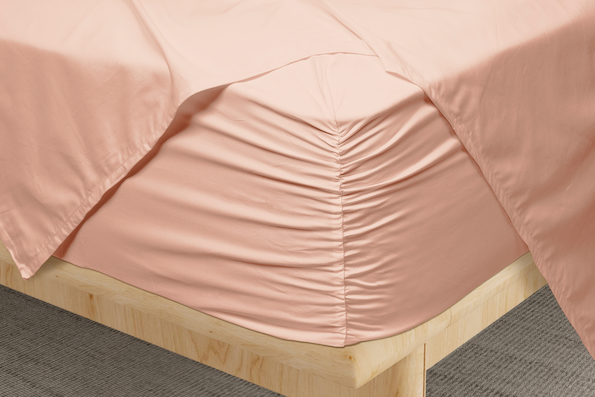 Close-up image showcasing the cinched Precision-Fit® corner of Blush Pink Weightless Cotton Sheets