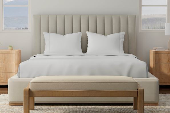 Image from the foot of a bed showcasing white Soft Touch sheets and pillowcases on the bed
