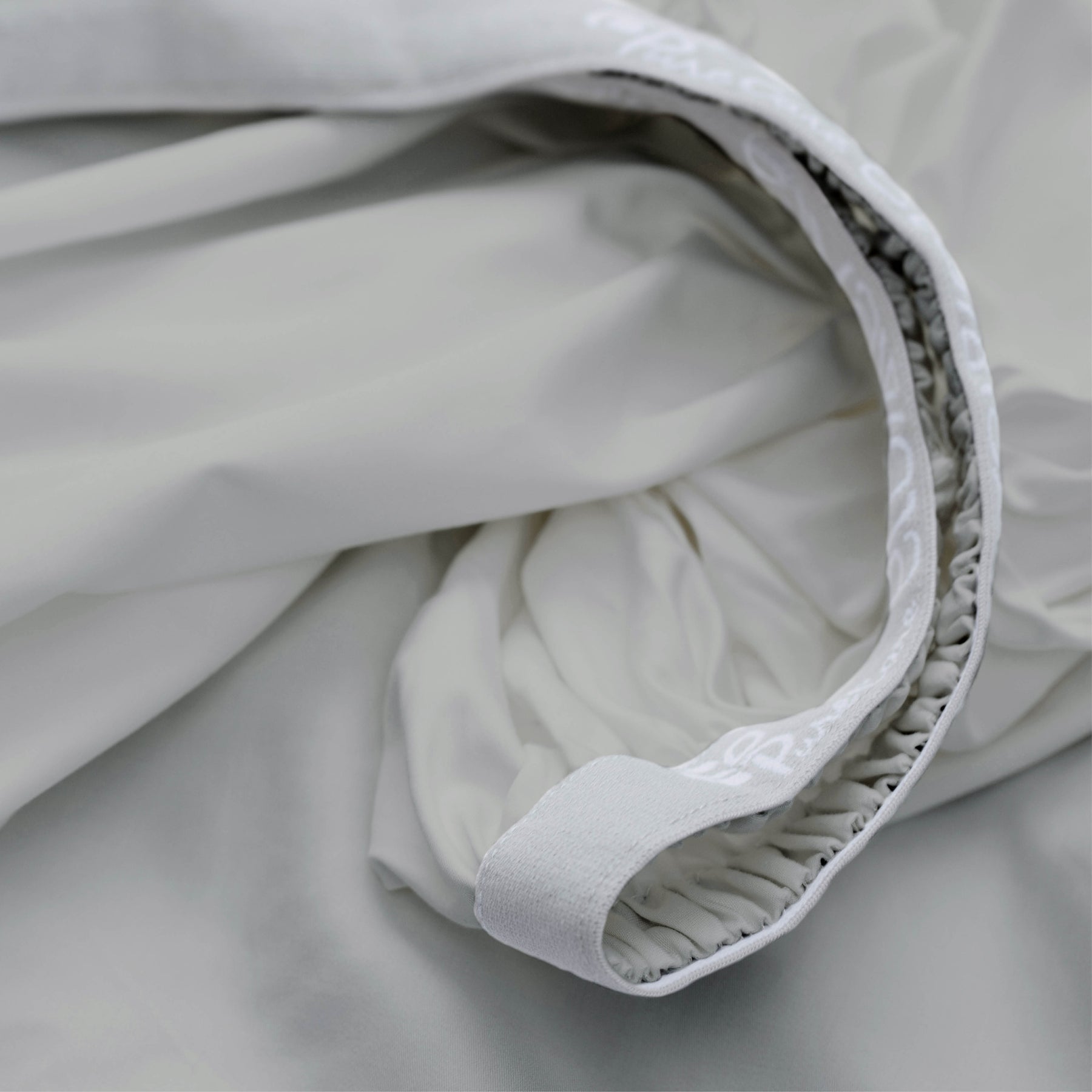 Image showcasing the Precision-Fit® elastic band on the bottom of a Dove Gray Recovery Viscose fitted sheet