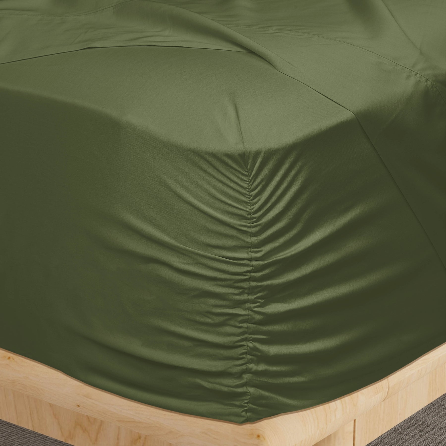 Image of a corner of a Moss Recovery Viscose fitted sheet showcasing the Precision-Fit® Corner