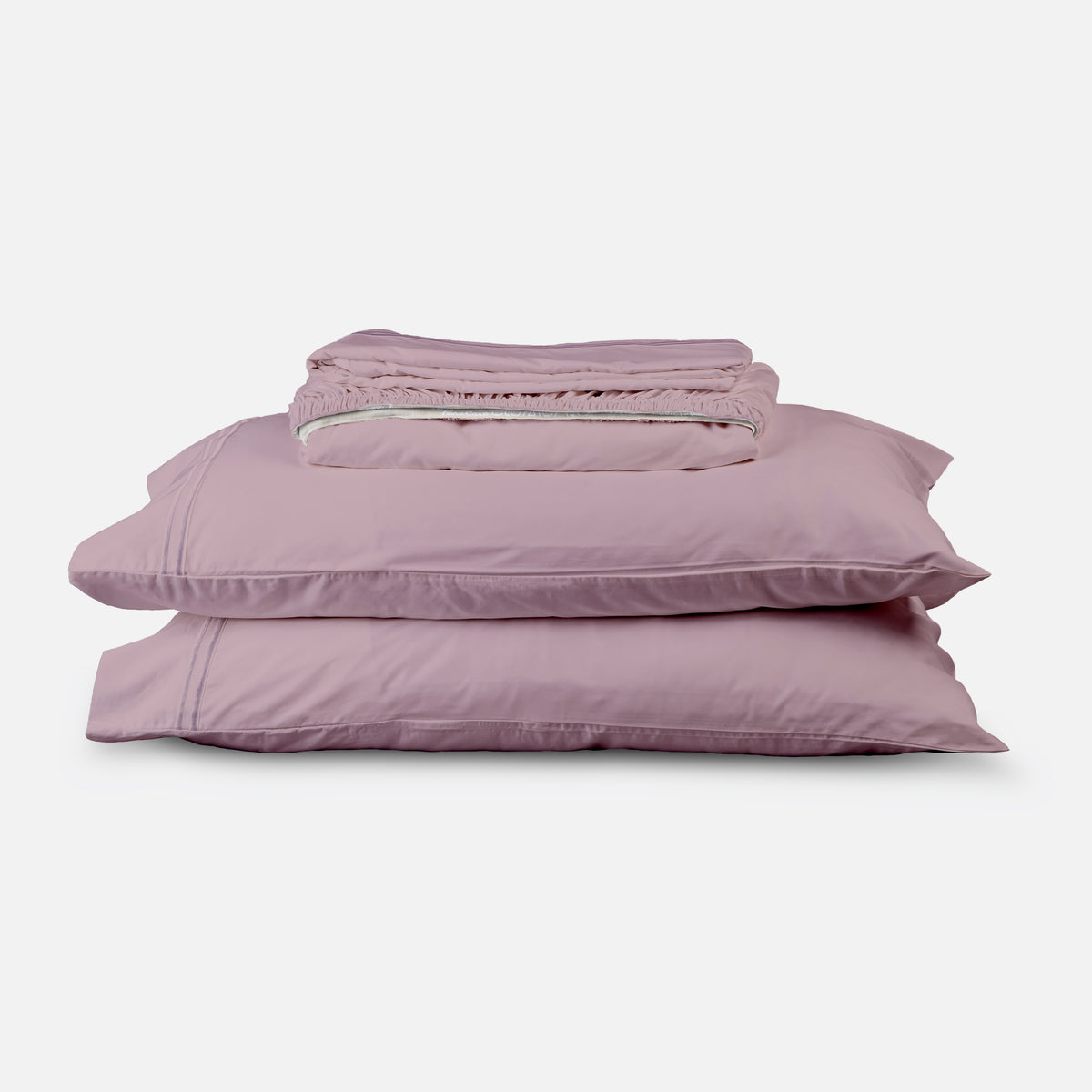 Image of a Lilac Refreshing TENCEL™ Lyocell sheet stack that includes (from top to bottom): a folded flat sheet, a folded fitted sheet, and two pillowcases on pillows