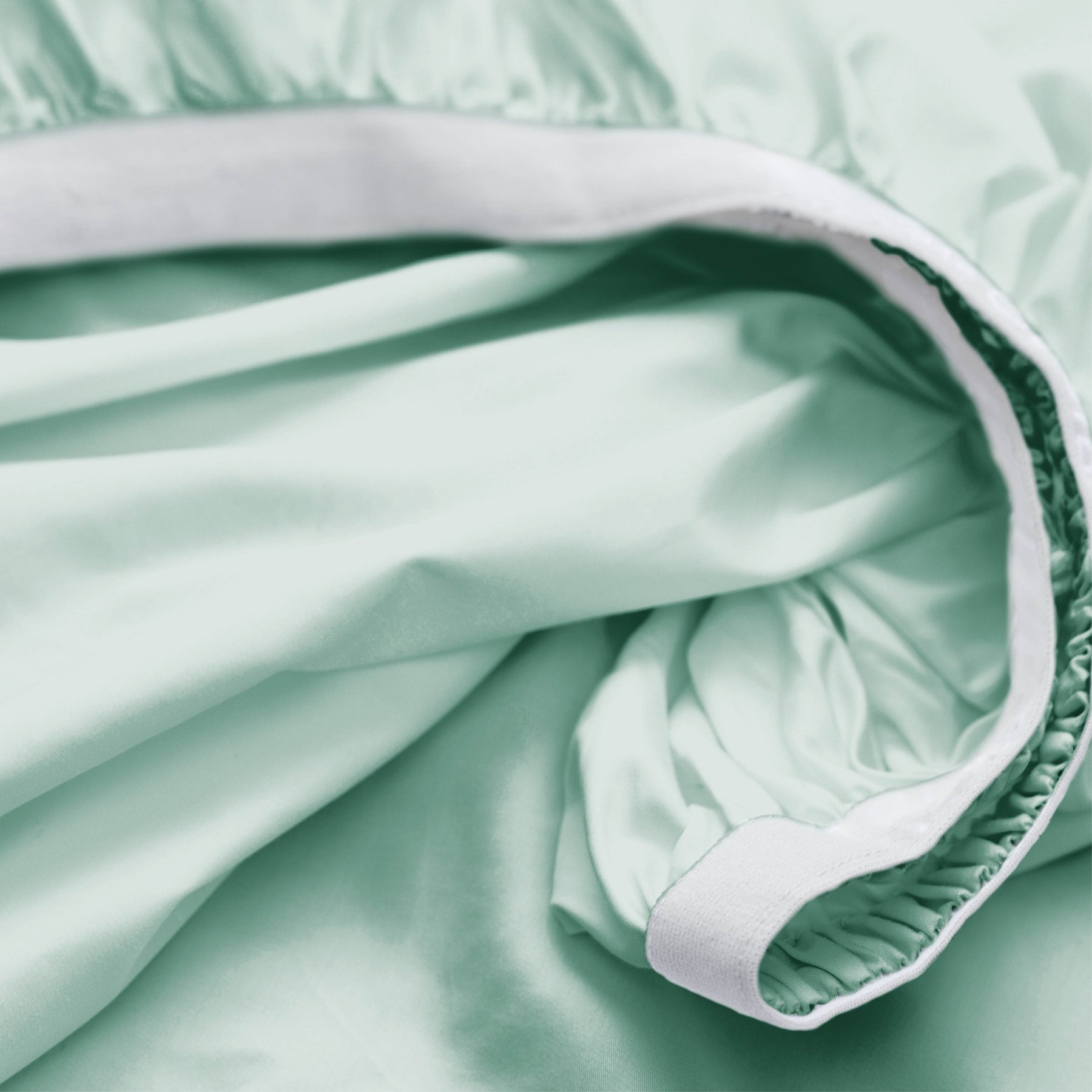 Image showcasing the Precision-Fit® elastic band on the bottom of a Seafoam Weightless Cotton fitted sheet