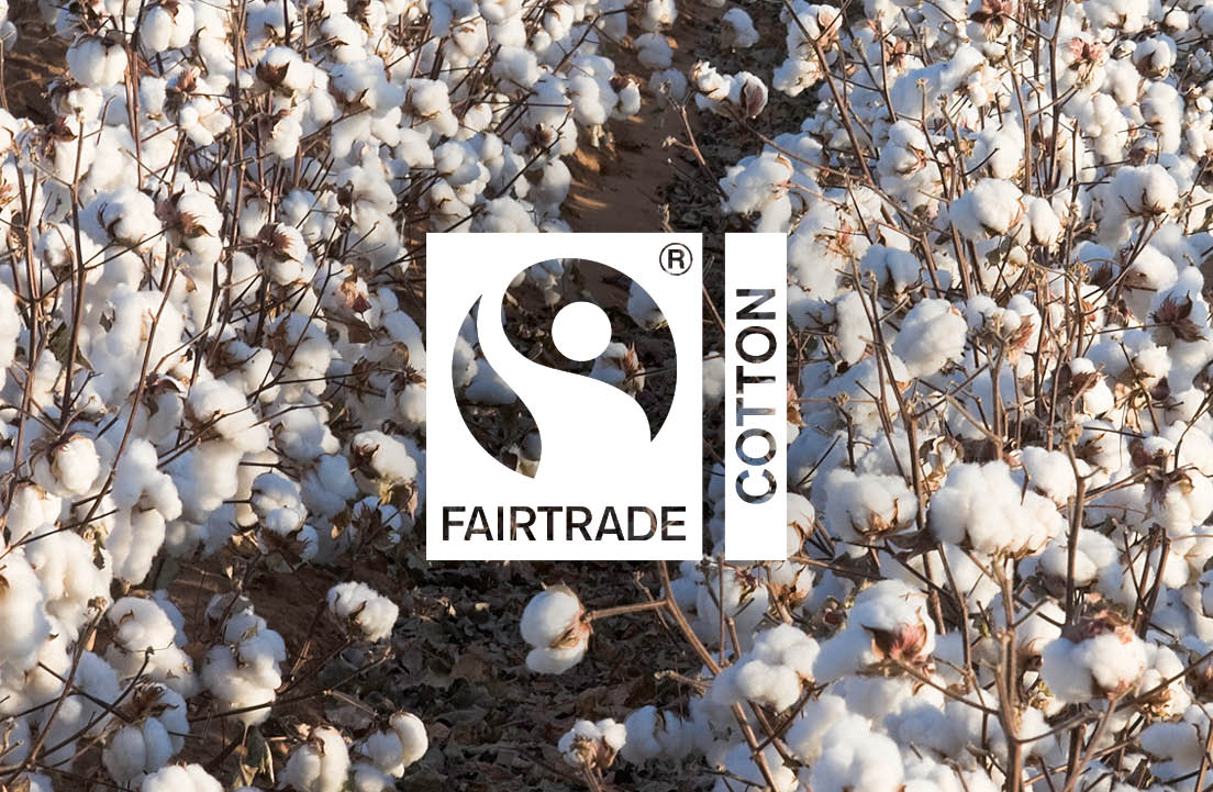 Image of a field of cotton with the logo for Fairtrade® Cotton in the middle