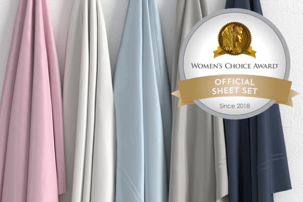 Image of all five color ways of Refreshing TENCEL™ Lyocell Sheet Set hanging in order of Lilac, White, Light Blue, Dove Gray, Celestial Blue with a sticker in the top right corner saying "Women's Choice Award Official Sheet Set Since 2018"